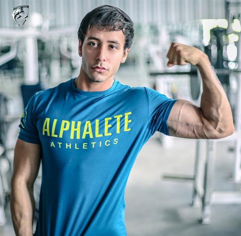 Fitness T-Shirt - Stylish Cotton Wear for Every Athlete worn by a muscular man in a gym.